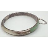 A silver, mother of pearl and jade panel bangle with push clasp & safety chain. Silver mark to