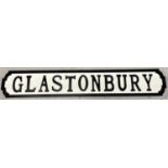 A modern painted wood sign for Glastonbury, in the style of an old street sign. Approx. 83cm long.