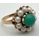 A vintage 9ct gold dress ring set with turquoise and pearls. Central round cabochon of blue