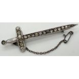 A vintage silver stone set brooch modelled as a sword, complete with safety chain. Set with 20 round