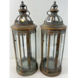 A pair of large slim circular shaped metal and glass panelled lanterns with hinged doors. 8 tall
