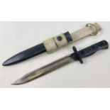 A vintage post WWII L.1.A.4 9600259 Bayonet with scabbard and canvas carry strap. S.M. also