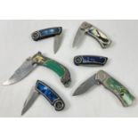 6 collectors penknives and survival knives. All with decorative handles. To include wolf design,