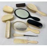 A collection of vintage ebony and bone handled dressing table mirrors, brushes & vanity items.