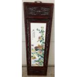 A large wooden framed ceramic Chinese panel depicting birds and flowers. Frame has decorative