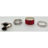 4 silver dress rings in varying conditions. To include a onyx set crossover style ring and a band