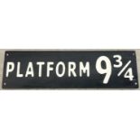 A modern painted wood Harry Potter Platform 9Â¾ sign, in black & white. Approx. 59cm long.