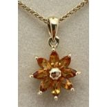 A 9ct gold flower design pendant set with 8 marquise cut citrine stones. On an 18" foxtail 9ct
