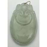 A carved icy jade pendant with a gold coloured metal looped bale. Pendant approx. 5.5cm x 3.5cm.
