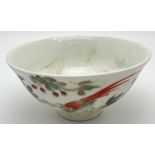 A small Chinese ceramic tea bowl with hand painted bird and blossom design to outer bowl. Signed