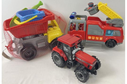 A modern battery operated fire truck by carousel. Together with a brand new plastic tipper truck