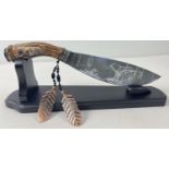 An ornamental Native American knife with wolf decoration to both sides of the blade. Imitation
