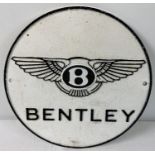 A Bentley circular shaped cast iron wall plaque, painted black & white. With fixing holes. Approx.