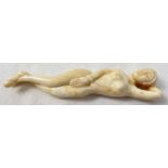 A small carved nude figure with polished finish, possibly bone. Approx. 13cm long.