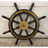 An antique brass bound dark wood maritime ships wheel with 8 turned spokes. Approx. 76cm diameter.