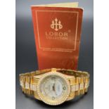 A ladies modern automatic wristwatch by Lobor Collection. Gold tone stainless steel strap and case
