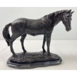 A bronze figure of a horse mounted on a black marble base. Approx. 22cm tall x 26cm long.