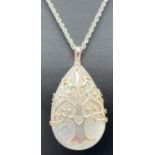A modern design teardrop shaped moonstone pendant with Tree Of Life design silver overlay. On a