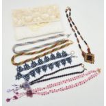 A cream satin beaded jewellery roll with 6 handmade faux pearl and glass bead necklaces. In