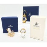 3 boxed small Swarovski crystal and gold tone metal collectibles. Comprising a Tilley lamp,