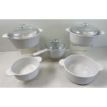 A collection of French Corning kitchen ware. Comprising: 2 lidded casserole dishes, a large