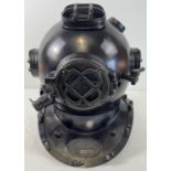 A full sized replica brown coloured metal mark V US Navy divers helmet. With glass panels and hinged