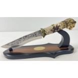 An ornamental knife with resin lions head detail to handle. Scroll and floral detail to handle and