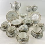 A late Victorian Japanese eggshell porcelain 12 setting teaset with handpainted scenic design and