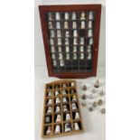 A collection of ceramic and metal thimbles in varying sizes and designs together with 2 small