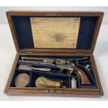 An antique 1851 U.S.A. .36 Navy Colt pistol with original box and accessories. Wooden grips with