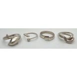 4 silver and white metal rings. To include wrap around dolphin ring and modern contemporary