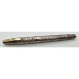 A vintage sterling silver cased Sheaffer fountain pen with 14k gold nib. Engraved criss-cross design