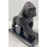 A bronze figure of a gorilla mounted on a black marble rectangular shaped base. Approx. 17cm tall