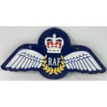 A painted cast iron RAF wings wall plaque, with fixing holes. Approx. 35cm long.
