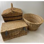 3 wicker items. A lined picnic basket with carry handle containing cutlery and cruet set, an oval