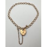A 9ct gold curb chain bracelet with padlock clasp and safety chain. Hallmarks to back of padlock.