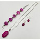 A matching set of silver and pink dyed agate jewellery. A pair of oval drop earrings, an oval