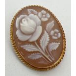 A carved rose design cameo brooch pendant in a 18ct gold mount. Brooch pin and folding bale to