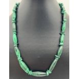A 20 inch Malachite graduating oval bead and chip necklace with sterling silver spring ring clasp.