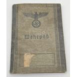 A World War II style Wehrpass conscript registration book Auiguist Folksdorf with identity photo.