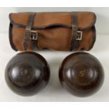 A pair of vintage wooden lawn bowls No. 4, with original canvas and leather case.