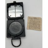 A Military Magnetic Marching Mk. 1 compass by T.G.Co, Ltd, Complete with instruction paper.