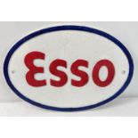 An Esso oval shaped painted cast iron wall plaque, in white blue & red. Approx. 22cm x 32.5cm.