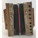An antique Imperial Accordion by J.F. Kalbe. In need of attention/restoration. Deep maroon and