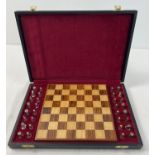A cased silver chess set with silver and silver gilt playing pieces and a wooden chessboard. Each