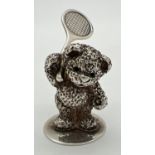 A small modern cast silver figurine of a teddy bear playing tennis. Hallmarked to base for Sheffield