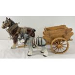 A large brown shire horse together with a smaller grey shire horse and a handmade wooden haycart.