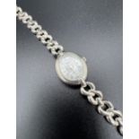 A ladies sterling silver quartz wristwatch by Carvel. Twist design link bracelet strap with extra
