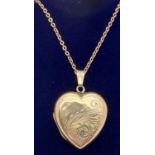 A vintage 9ct gold front and back heart shaped locket with half floral engraving to front. On a 17