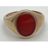A 9ct gold signet ring set with an oval of carnelian. Full hallmarks to inside of ring. Ring size Q.